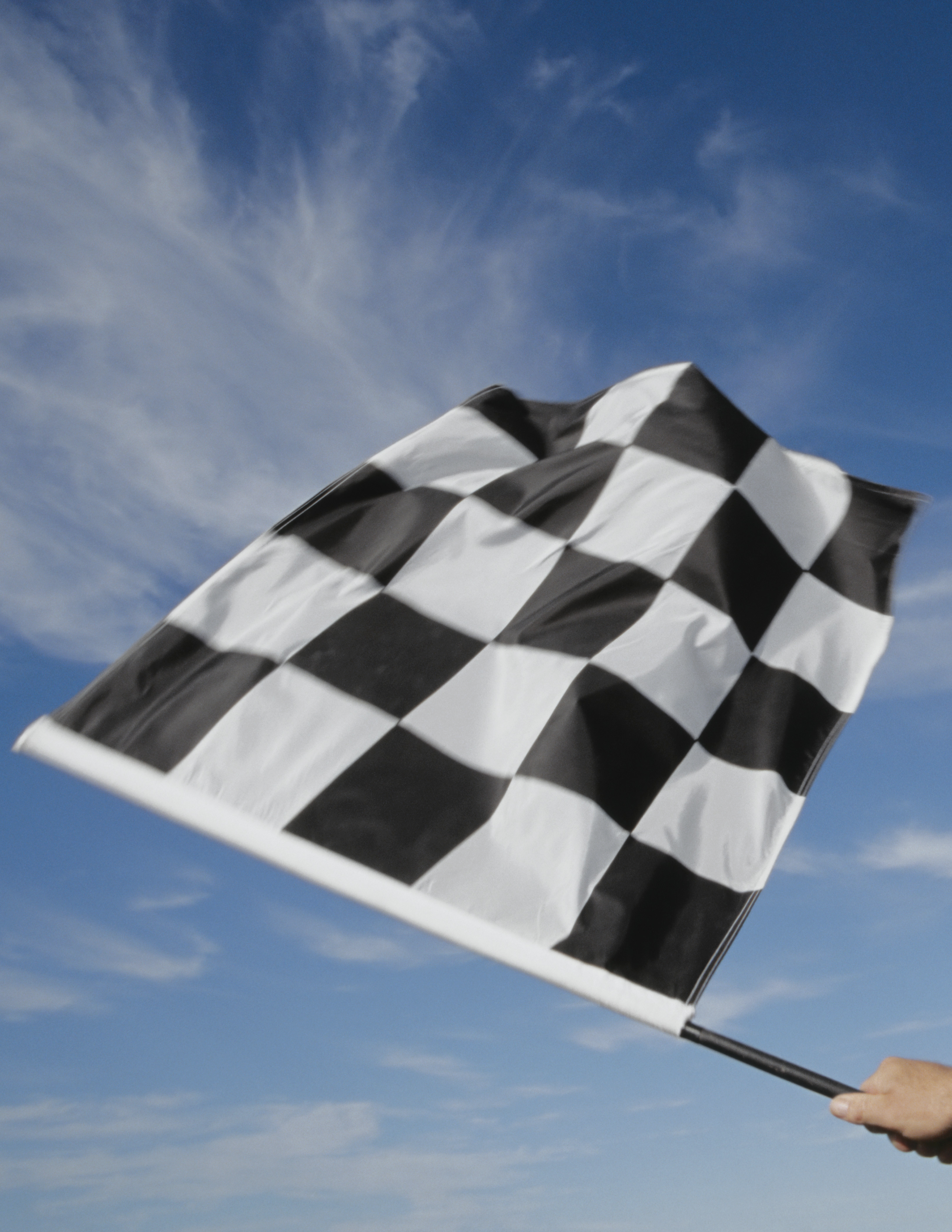 Man waving checkered flag (blurred motion)